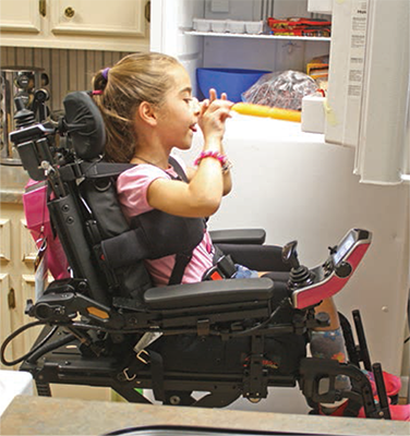 Girl reaches freezer